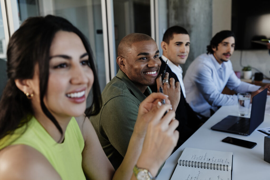 A group of colleagues sitting and talking at a table together.